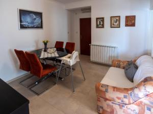 a living room with a table and chairs and a couch at Apartments and rooms by the sea Palit, Rab - 5044 in Rab