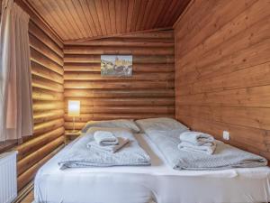 a bedroom with a bed in a wooden wall at im Brixental II in Wörgl