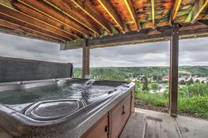 a hot tub on a deck with a view at Spruce Lodge in Red Lodge
