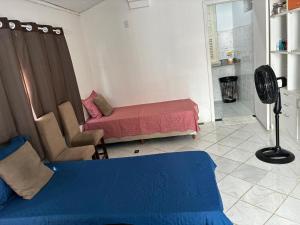 a living room with a bed and a fan at Casa Nossa Senhora de Nazaré 2 in Belém