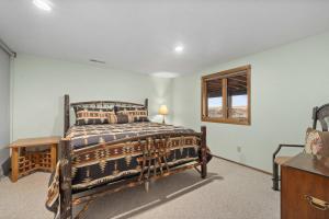 a bedroom with a wooden bed and a window at Spruce Lodge in Red Lodge +65 photos