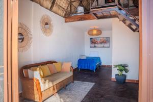 a living room with a couch and a bed at Hotel y Restaurante Buganvilias in Las Aradas