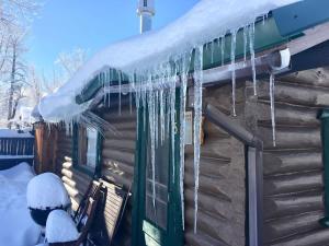 a load of icicles hanging from the roof of a log cabin at Wild Bills Cabin in Red Lodge