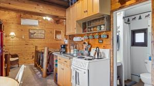 a kitchen with a stove and a white refrigerator at Wild Bills Cabin in Red Lodge