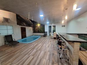 a large room with a pool in the middle of it at Casa compartilhada com Quarto e Suite no Parque 10 in Manaus