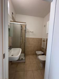 a bathroom with two toilets and a sink and a shower at Affittacamere Casa Lucia in La Spezia
