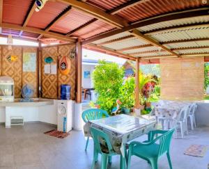 a kitchen and dining room with a table and chairs at Astillo's Guest Houses in Moalboal +21 photos