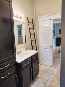 a bathroom with a sink and a mirror and a ladder at Cornerstone West Lower Unit in Savannah +30 photos