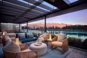 a patio with a view of a lake and mountains at ROKI Collection in Queenstown