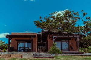 a brick house with large windows at Mayan Farm House and Villas, Noosa Hinterland in Kin Kin
