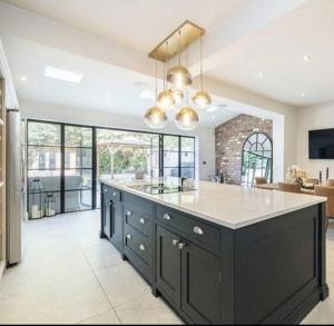 a kitchen with a large island with a counter top at Layla Grove in Grove Park