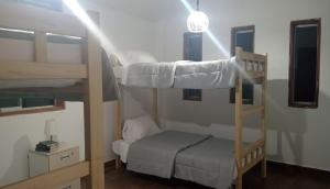 a room with two bunk beds and a small bed at Casa Blanca Andina in Cajamarca