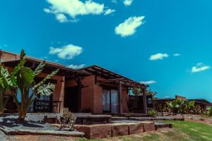 a house with a palm tree in front of it at Mayan Farm House and Villas, Noosa Hinterland in Kin Kin