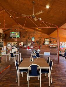 a dining room with tables and chairs in a building at Cadney Park Accommodation in Coober Pedy