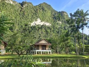 a house in front of a mountain at Lost Horizon Resort - Khao Sok in Khao Sok National Park