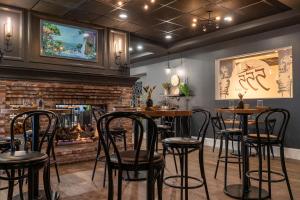 a restaurant with tables and chairs in front of a fireplace at The Federal in Brunswick