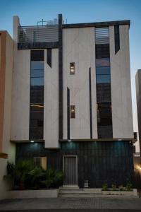 a building with lights on the side of it at Nozol Tabba in Medina