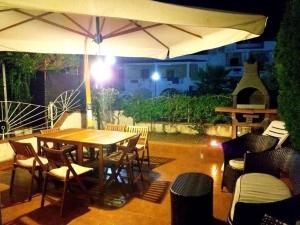 a table and chairs with an umbrella on a patio at Villa Lorena sul mare calabria in San Nicola Arcella +51 photos