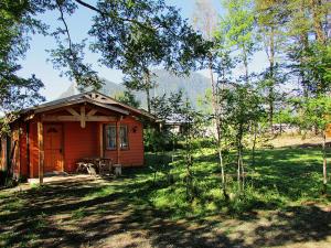 a small house in the middle of a field at Cabañas Entremontañas Coñaripe in Coñaripe