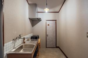 a kitchen with a sink and a counter top at 松本市の一棟貸しのプライベート邸宅 in Matsumoto +71 photos