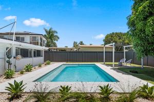 a swimming pool in the backyard of a house at Pet Friendly Beach House with pool - Sleeps 10 in Urangan