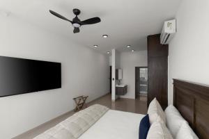 a living room with a couch and a flat screen tv at Casa del Vistas Pedregal in Cabo San Lucas