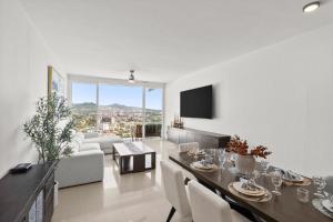 a living room with a dining table and a couch at Casa del Vistas Pedregal in Cabo San Lucas