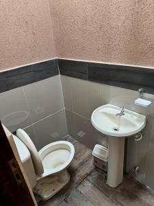 a bathroom with a toilet and a sink at Complejos Residenciales Las Lomitas in San Lorenzo de la Frontera +20 photos