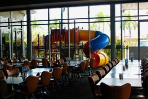 a restaurant with tables and chairs and a playground at The Mayfair Emerald in Emerald +61 photos