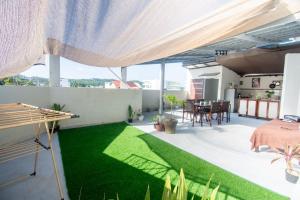 a patio with green grass in a house at ILA Apartelle Boracay in Boracay