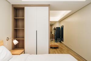 a bedroom with a bed and a sliding glass door at Dragon's Keep BNB near NAIA and MOA in Manila +28 photos