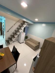 a living room with a couch and a staircase at APART HOTEL Wm in Belém
