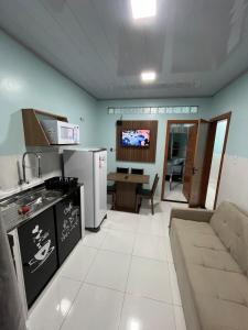 a kitchen and living room with a couch and a stove at APART HOTEL Wm in Belém