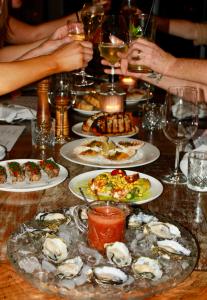 a table with plates of oysters and food on it at The Mayfair Emerald in Emerald