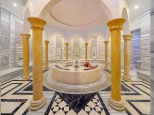 a large room with a fountain in the middle of a building at Rixos Borovoe in Borovoye