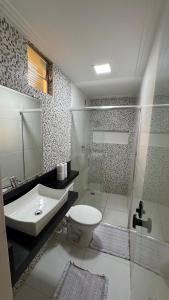 a bathroom with a sink and a toilet and a shower at Casa ampla em belém in Belém