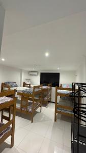 a room with several beds and a flat screen tv at Casa ampla em belém in Belém +13 photos