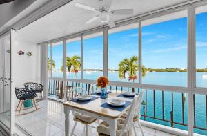 a dining room with a table and views of the water at The viewpoint in Marathon