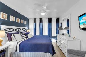 a blue and white bedroom with a bed and a dresser at The viewpoint in Marathon +21 photos