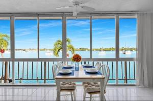 a dining room with a table and a view of the water at The viewpoint in Marathon