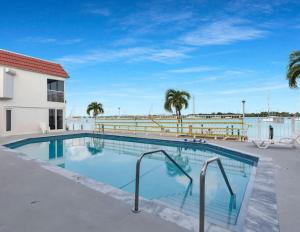 a swimming pool with palm trees and a building at The viewpoint in Marathon