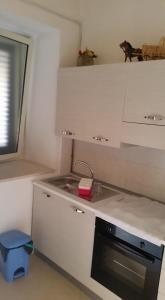 a small kitchen with a sink and a stove at Casa Vacanze Da Giusy in Matera