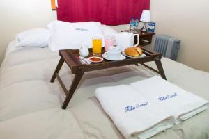 a tray of food on a table on a bed at AMARU Palace in Machu Picchu +44 photos
