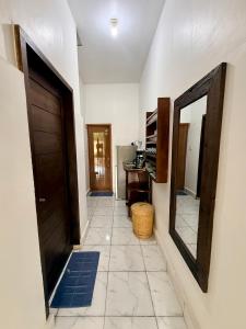a hallway with a door and a mirror at Solara Gili Air in Gili Islands