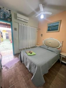 a bedroom with a bed and a ceiling fan at Pousada Morada dos Guarás in Ilha Comprida