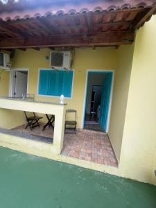 a house with a patio and a table and water at Pousada Morada dos Guarás in Ilha Comprida