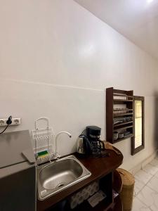 a kitchen with a sink and a counter top at Solara Gili Air in Gili Islands