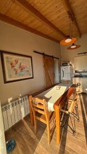 a dining room with a table and a kitchen at Patagonia in Trevelín +30 photos
