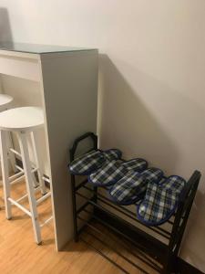 a small room with a table and a shelf with cushions at 1 Bedroom Arezzo Condotel in Davao City