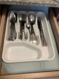 a tray with silver utensils on a table at 1 Bedroom Arezzo Condotel in Davao City